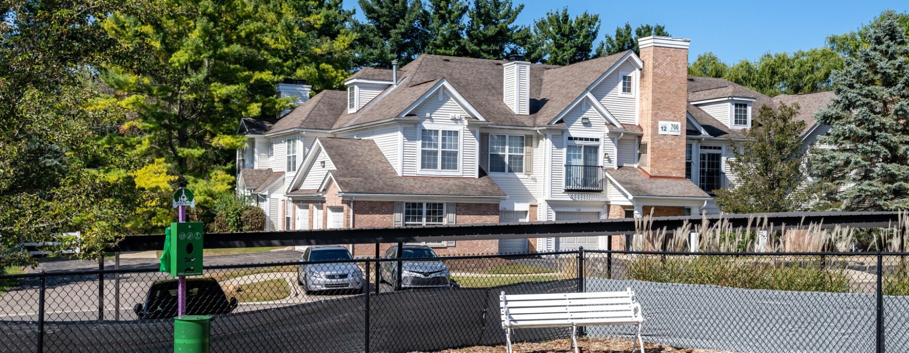 a dog park with a building in background