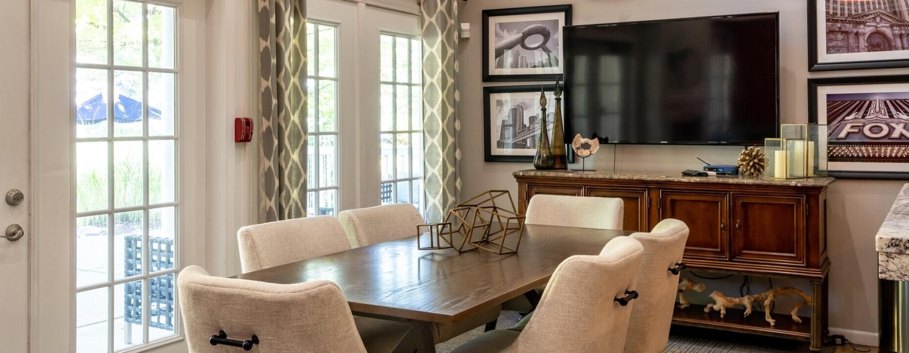 a living room with a table and chairs